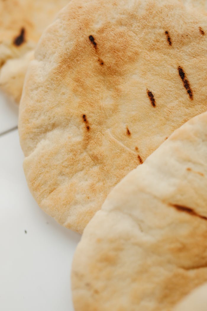 Close-up of freshly baked pita bread showcasing its texture and crispness.